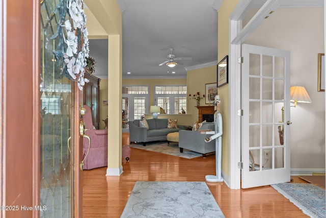 155 Mckenzie Rd E, Pinehurst, NC 28374 - foyer entrance with wood finished floors, ceiling fan, ornamental molding, baseboards, and a fireplace