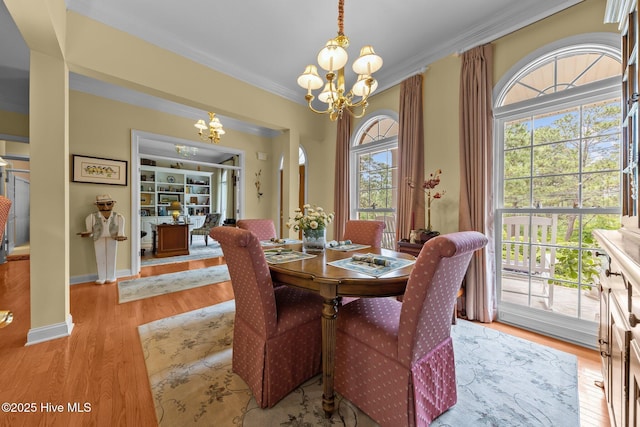 155 Mckenzie Rd E, Pinehurst, NC 28374 - dining space with a chandelier, ornamental molding, wood finished floors, and baseboards