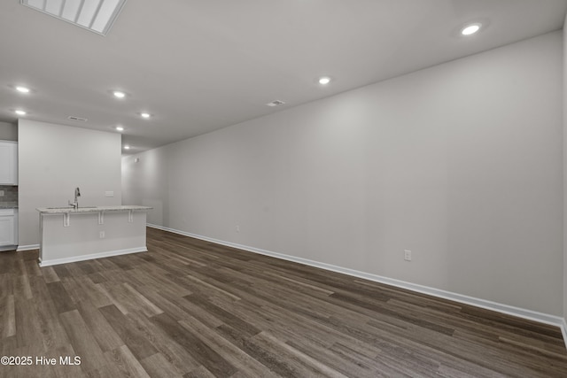 258 Arnette Dr Unit 81B, Ocean Isle Beach, NC 28469 - unfurnished living room featuring dark wood finished floors and recessed lighting
