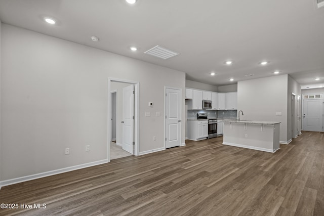 258 Arnette Dr Unit 81B, Ocean Isle Beach, NC 28469 - unfurnished living room with wood finished floors and recessed lighting