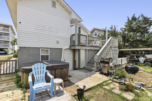 805 Carolina Beach Ave N, Carolina Beach, NC 28428 - rear view of house with a hot tub, a deck, and stairs