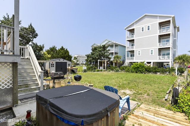 805 Carolina Beach Ave N, Carolina Beach, NC 28428 - deck featuring a hot tub, stairs, a grill, and a yard