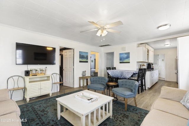 805 Carolina Beach Ave N, Carolina Beach, NC 28428 - living room with ornamental molding, wood finished floors, ceiling fan, and baseboards