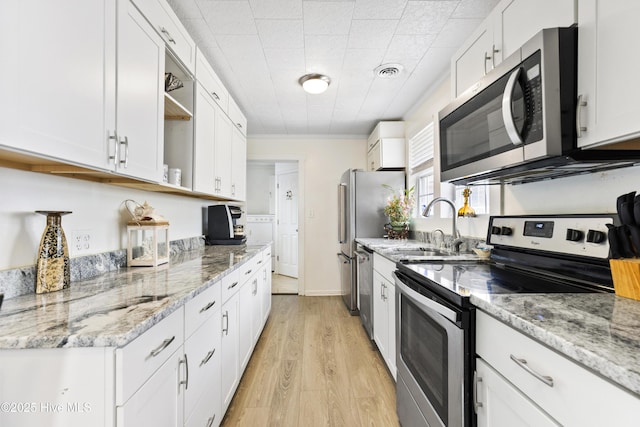 805 Carolina Beach Ave N, Carolina Beach, NC 28428 - kitchen featuring stainless steel appliances, a sink, white cabinetry, and crown molding