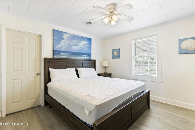 805 Carolina Beach Ave N, Carolina Beach, NC 28428 - bedroom featuring crown molding, wood finished floors, baseboards, and ceiling fan