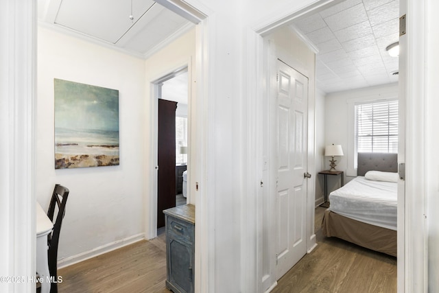 805 Carolina Beach Ave N, Carolina Beach, NC 28428 - bedroom with wood finished floors, crown molding, baseboards, attic access, and a closet