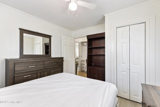 805 Carolina Beach Ave N, Carolina Beach, NC 28428 - bedroom with crown molding, light wood-type flooring, a closet, and ceiling fan