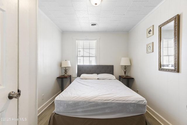 805 Carolina Beach Ave N, Carolina Beach, NC 28428 - bedroom featuring crown molding, baseboards, and wood finished floors