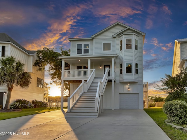 232 Shell Dr, Sneads Ferry, NC 28460 - beach home featuring stairway, driveway, a porch, board and batten siding, and an attached garage