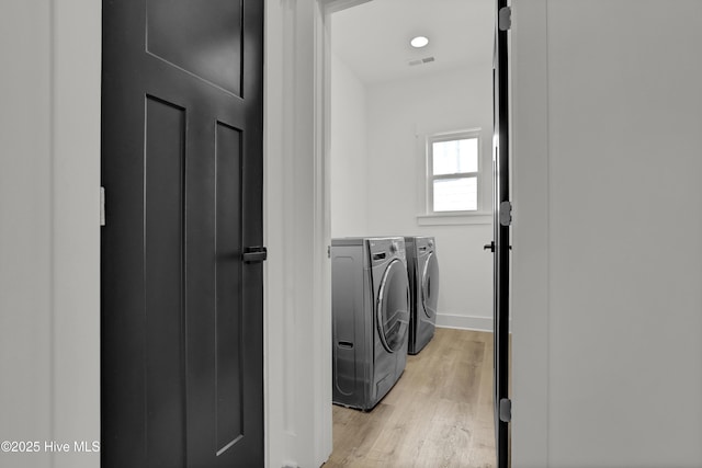232 Shell Dr, Sneads Ferry, NC 28460 - laundry area with washer and dryer, light wood finished floors, and baseboards