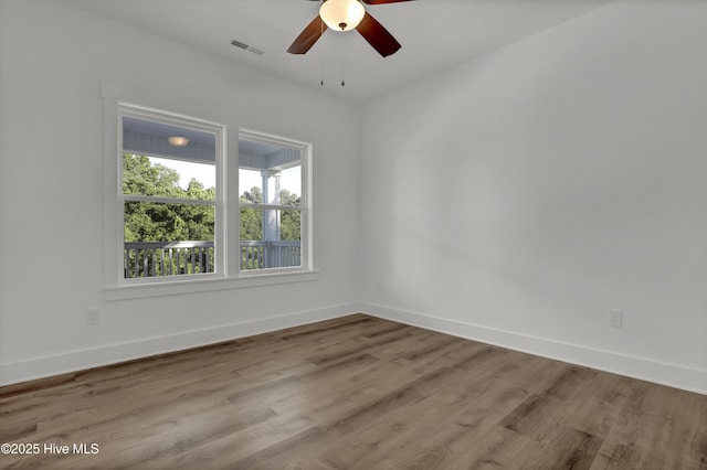 232 Shell Dr, Sneads Ferry, NC 28460 - empty room with a ceiling fan, wood finished floors, and baseboards
