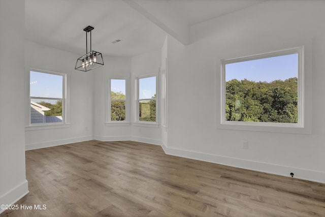 232 Shell Dr, Sneads Ferry, NC 28460 - spare room with a chandelier, baseboards, and wood finished floors