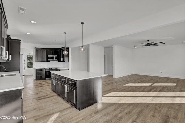 232 Shell Dr, Sneads Ferry, NC 28460 - kitchen featuring stainless steel appliances, a sink, a ceiling fan, light wood finished floors, and recessed lighting