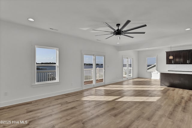 232 Shell Dr, Sneads Ferry, NC 28460 - unfurnished living room featuring light wood-type flooring, a ceiling fan, baseboards, and recessed lighting