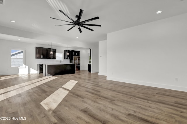 232 Shell Dr, Sneads Ferry, NC 28460 - unfurnished living room featuring light wood-style flooring, ceiling fan, recessed lighting, and baseboards