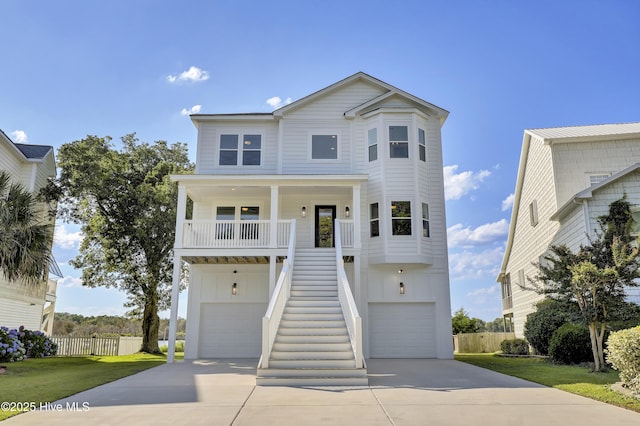 232 Shell Dr, Sneads Ferry, NC 28460 - beach home featuring concrete driveway, an attached garage, stairs, covered porch, and board and batten siding