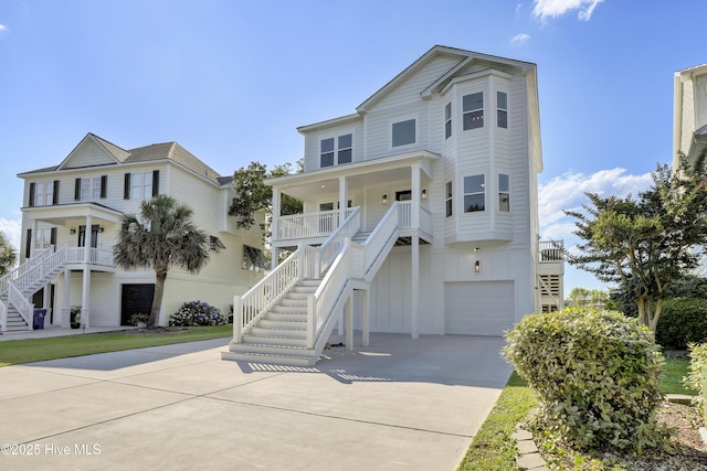 232 Shell Dr, Sneads Ferry, NC 28460 - beach home with stairs, a porch, driveway, and an attached garage