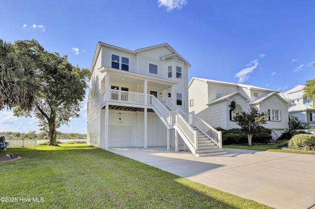 232 Shell Dr, Sneads Ferry, NC 28460 - beach home featuring driveway, a front lawn, a garage, stairs, and a porch