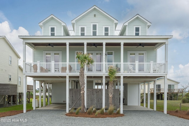 1753 New River Inlet Rd, North Topsail Beach, NC 28460 - raised beach house with a ceiling fan, a carport, and french doors