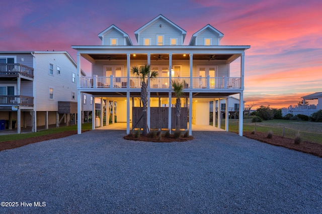 1753 New River Inlet Rd, North Topsail Beach, NC 28460 - raised beach house with a carport, driveway, ceiling fan, and french doors