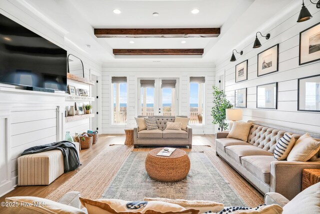 1753 New River Inlet Rd, North Topsail Beach, NC 28460 - living area with plenty of natural light, wood finished floors, beamed ceiling, and wooden walls