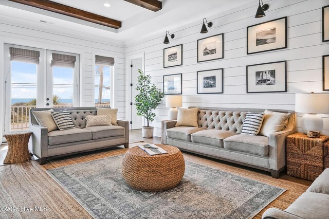 1753 New River Inlet Rd, North Topsail Beach, NC 28460 - living area with plenty of natural light, wood finished floors, beamed ceiling, and wooden walls