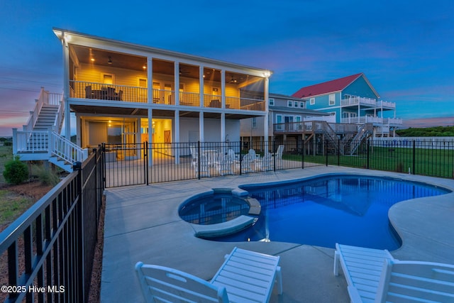 1753 New River Inlet Rd, North Topsail Beach, NC 28460 - pool at dusk featuring stairs, a patio, a fenced backyard, and a pool with connected hot tub