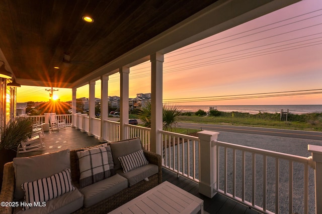 1753 New River Inlet Rd, North Topsail Beach, NC 28460 - deck at dusk with a water view and an outdoor living space