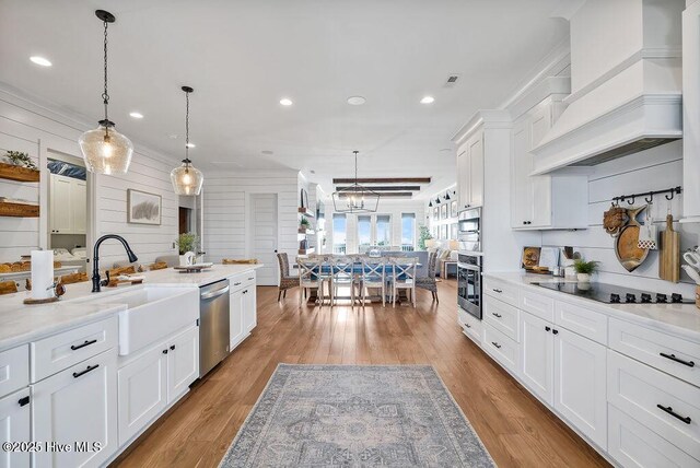 1753 New River Inlet Rd, North Topsail Beach, NC 28460 - dining area with light wood finished floors, beam ceiling, and a chandelier