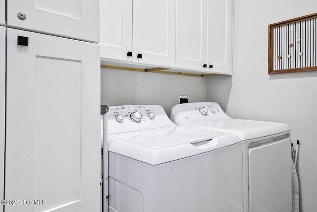 1753 New River Inlet Rd, North Topsail Beach, NC 28460 - laundry room featuring washing machine and clothes dryer and cabinet space