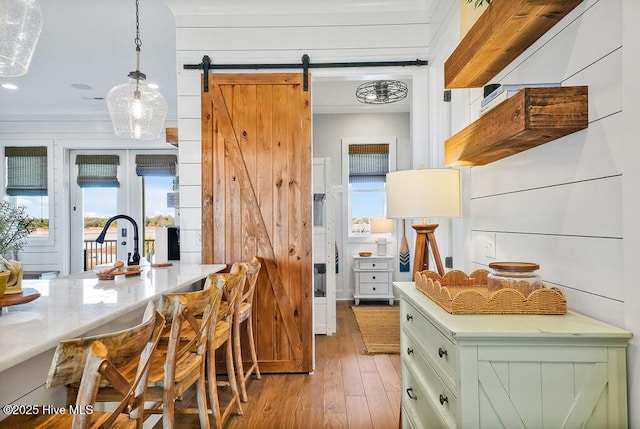 1753 New River Inlet Rd, North Topsail Beach, NC 28460 - kitchen with healthy amount of natural light, light wood-type flooring, decorative light fixtures, light countertops, and recessed lighting