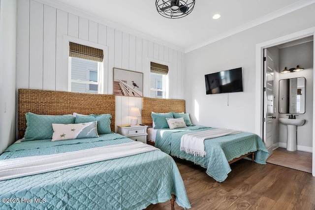 1753 New River Inlet Rd, North Topsail Beach, NC 28460 - bedroom with crown molding, wood finished floors, baseboards, recessed lighting, and a sink