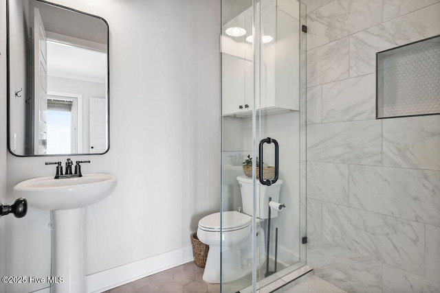 1753 New River Inlet Rd, North Topsail Beach, NC 28460 - bathroom featuring a stall shower, toilet, baseboards, and tile patterned flooring