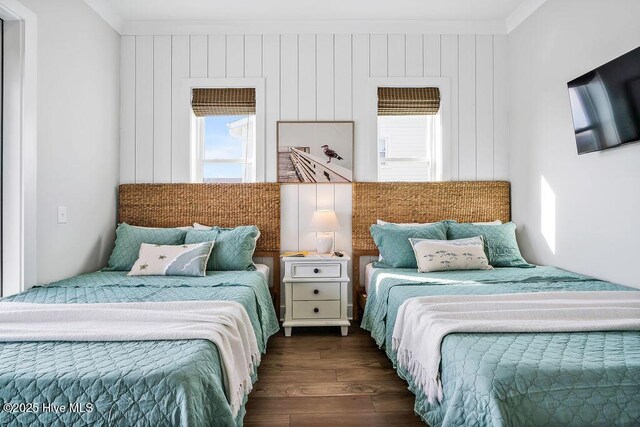 1753 New River Inlet Rd, North Topsail Beach, NC 28460 - bedroom with ornamental molding and dark wood-type flooring