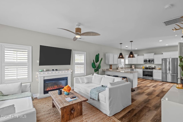 527 Everett Glades, Sneads Ferry, NC 28460 - living area with ceiling fan, light wood finished floors, recessed lighting, and a glass covered fireplace