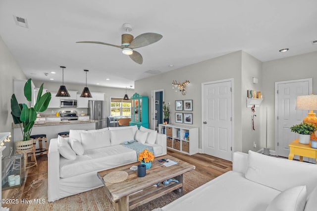 527 Everett Glades, Sneads Ferry, NC 28460 - living area featuring dark wood finished floors, a ceiling fan, and recessed lighting