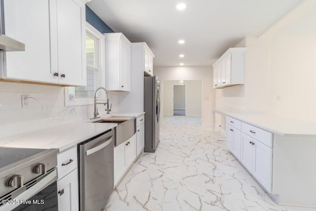 785 Daniels Rd, Corapeake, NC 27926 - kitchen featuring stainless steel appliances, wall chimney exhaust hood, a sink, recessed lighting, and light marble finish flooring