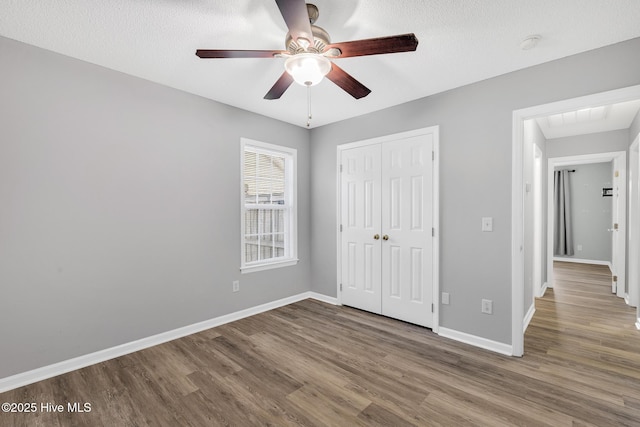 422 Point View Ct, Wilmington, NC 28411 - unfurnished bedroom with wood finished floors, a closet, baseboards, and ceiling fan