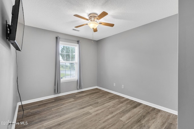 422 Point View Ct, Wilmington, NC 28411 - unfurnished room with a textured ceiling, wood finished floors, ceiling fan, and baseboards