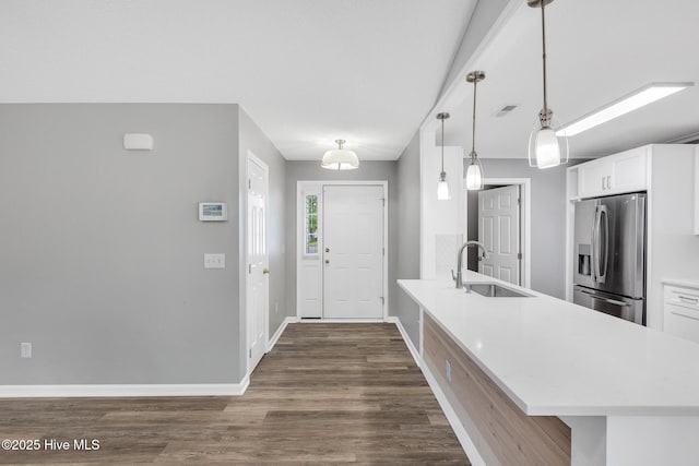 422 Point View Ct, Wilmington, NC 28411 - kitchen featuring stainless steel refrigerator with ice dispenser, a sink, light countertops, white cabinetry, and baseboards