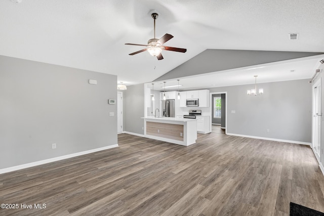 422 Point View Ct, Wilmington, NC 28411 - unfurnished living room featuring ceiling fan, a chandelier, vaulted ceiling, wood finished floors, and baseboards