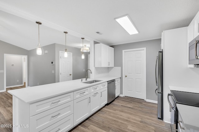 422 Point View Ct, Wilmington, NC 28411 - kitchen with appliances with stainless steel finishes, a peninsula, a sink, and white cabinetry