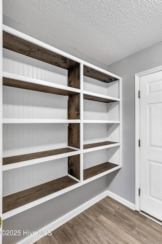 422 Point View Ct, Wilmington, NC 28411 - detailed view of wood finished floors, a textured ceiling, and baseboards