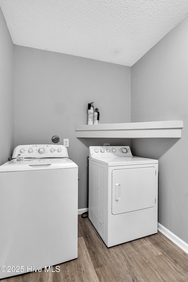 422 Point View Ct, Wilmington, NC 28411 - washroom with washing machine and dryer, wood finished floors, a textured ceiling, and baseboards