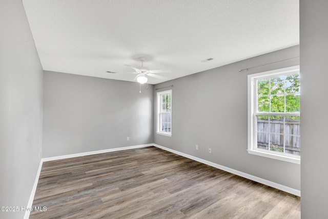 422 Point View Ct, Wilmington, NC 28411 - empty room featuring baseboards, wood finished floors, and a ceiling fan