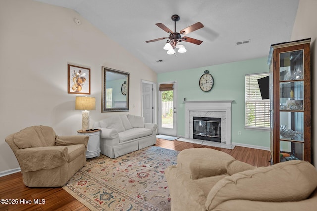 7100 Farrington Farms Dr, Wilmington, NC 28411 - living room with lofted ceiling, wood finished floors, ceiling fan, a premium fireplace, and baseboards
