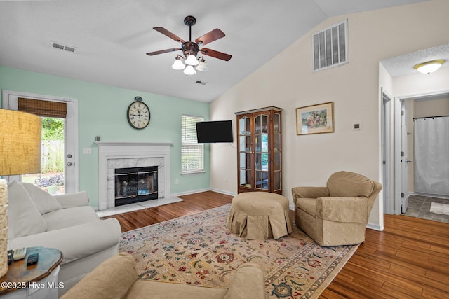 7100 Farrington Farms Dr, Wilmington, NC 28411 - living room with a ceiling fan, wood finished floors, vaulted ceiling, a fireplace, and baseboards