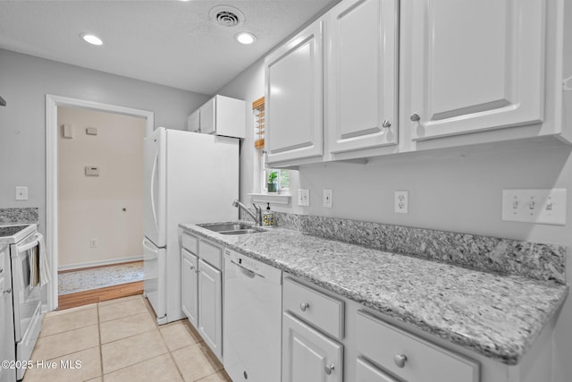 7100 Farrington Farms Dr, Wilmington, NC 28411 - kitchen featuring white appliances, a sink, white cabinets, light tile patterned flooring, and light stone counters
