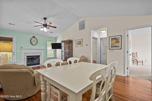 7100 Farrington Farms Dr, Wilmington, NC 28411 - dining room with wood finished floors, ceiling fan, a high end fireplace, and vaulted ceiling