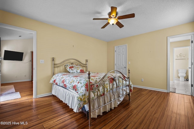 7100 Farrington Farms Dr, Wilmington, NC 28411 - bedroom featuring wood finished floors, baseboards, ensuite bath, ceiling fan, and a textured ceiling